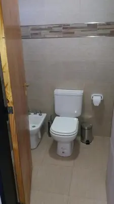 a bathroom with a toilet and a sink at Posada Entre Dos in Mina Clavero