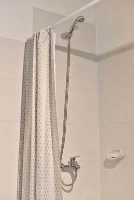 a shower with a curtain in a bathroom at 370 General Simón Bolívar in Cordoba