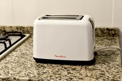 a white toaster sitting on a counter next to a stove at 370 General Simón Bolívar in Cordoba