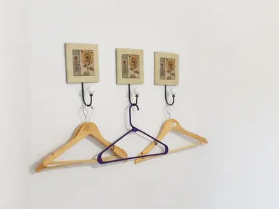 a wooden hanger with three pictures on a wall at VILLA MIA in Villa Carlos Paz