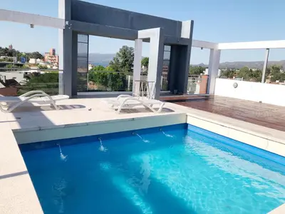 a swimming pool on the roof of a building at VILLA MIA in Villa Carlos Paz
