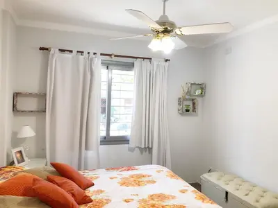 a bedroom with a ceiling fan and a bed at VILLA MIA in Villa Carlos Paz