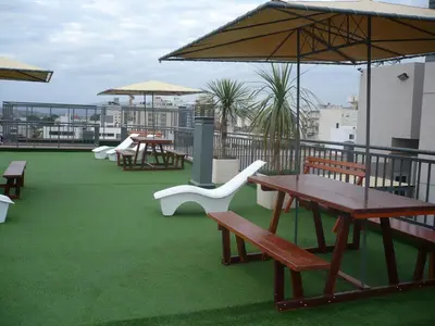a deck with picnic tables and chairs on a roof at MIralejos II in Villa Carlos Paz