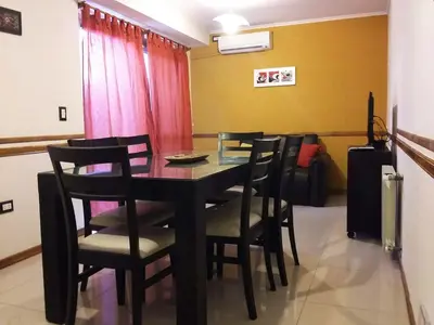 a dining room with a black table and chairs at MIralejos II in Villa Carlos Paz