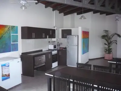 a kitchen with a refrigerator and a table with chairs at MIralejos II in Villa Carlos Paz