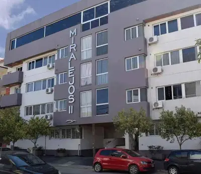 a building with a sign on the front of it at MIralejos II in Villa Carlos Paz