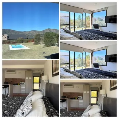 a room with a bed and a view of a pool at La Macarena Suites in Villa General Belgrano