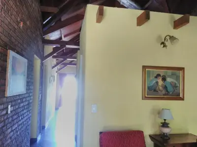 a hallway with a painting of two people on the wall at Casa en Playa Perelli in Villa Carlos Paz