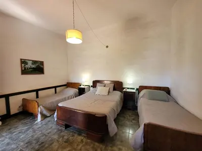 a hospital room with two beds and a lamp at Hostal Antigua Casa Criolla in Los Reartes