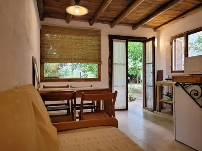 a kitchen and dining room with a table and chairs at Hostal Antigua Casa Criolla in Los Reartes