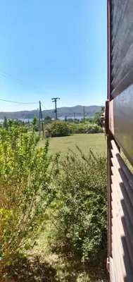 a view of a field from a window of a house at La Rosada in Potrero de Garay