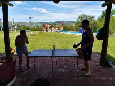 two people playing ping pong on a ping pong table at La Rosada in Potrero de Garay