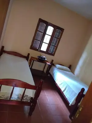 two beds in a room with a window at La Rosada in Potrero de Garay