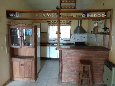a kitchen with an island in the middle of a room at La Rosada in Potrero de Garay