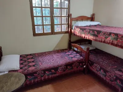 a room with two bunk beds and a table at La Rosada in Potrero de Garay