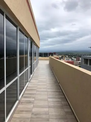 a balcony of a building with a view of a city at Dpto Teatro Melos microcentro pileta y cochera in Villa Carlos Paz