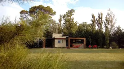 a small house in a field with trees at cabañas Tierra Kamiare 1 in Amboy