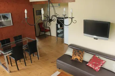 a living room with a couch and a table at cabañas Tierra Kamiare 1 in Amboy