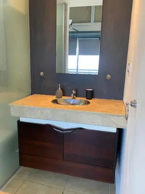 a bathroom with a sink and a mirror at DEPARTAMENTO SUITE DE LUXE EN EL CENTRO in Cordoba