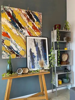 a wooden table with a painting on a wall at DEPARTAMENTO SUITE DE LUXE EN EL CENTRO in Cordoba