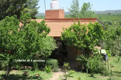a small house with a chimney on top of it at Cabañas A la Maison in Mina Clavero