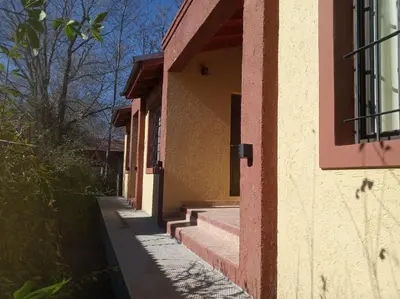 a building with stairs on the side of it at Aldea del Río in Santa Rosa de Calamuchita