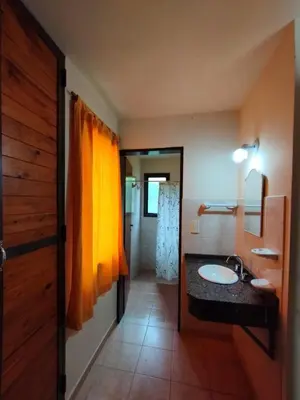 a bathroom with a sink and a mirror at Aldea del Río in Santa Rosa de Calamuchita