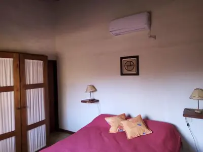 a bedroom with a pink bed with two lamps on it at Fincas del Huacle in Nono