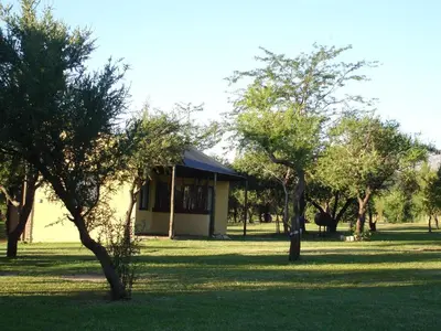 a house in the middle of a field with trees at Fincas del Huacle in Nono