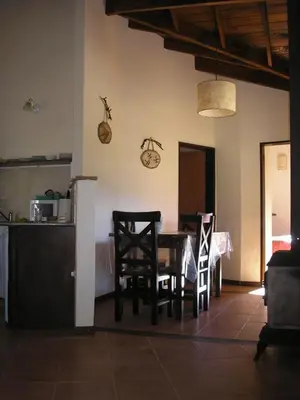 a kitchen and dining room with a table and chairs at Fincas del Huacle in Nono