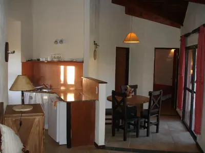 a kitchen with a table and chairs in a room at Fincas del Huacle in Nono