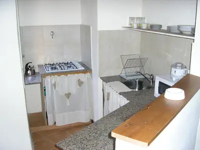 a small kitchen with a stove and a sink at Fincas del Huacle in Nono
