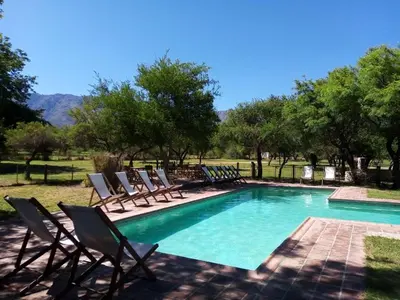 a swimming pool with lounge chairs next to at Fincas del Huacle in Nono