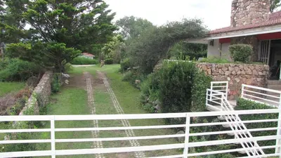 a white fence in front of a house at Mi Sueño in San Antonio de Arredondo