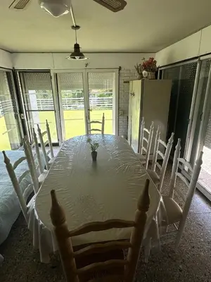 a dining room with a table with chairs and a tableablish at Mi Sueño in San Antonio de Arredondo