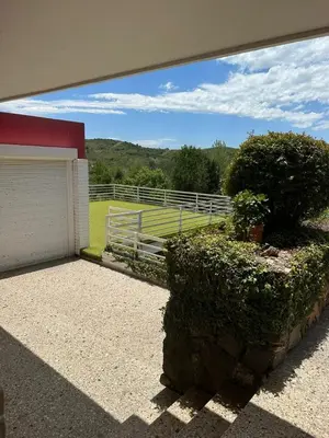 a building with a fence and a field of grass at Mi Sueño in San Antonio de Arredondo