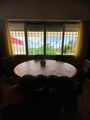 a wooden table in a room with windows at Mi Sueño in San Antonio de Arredondo