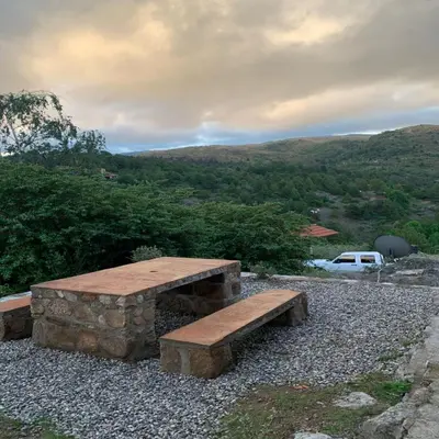 a bench sitting on top of a pile of rocks at La Ponderosa Cumbrecita in La Cumbrecita