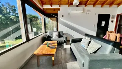 a living room with a couch and a coffee table at Fincas del Faldeo in Villa General Belgrano