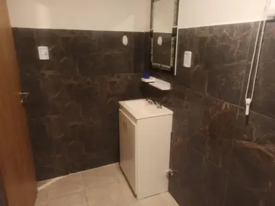 a bathroom with a toilet and a sink and a shower at Cabañas Noscohue in Villa General Belgrano