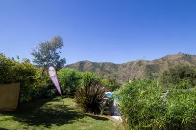 a garden with a large purple boat in the grass at Cabañas Noscohue in Villa General Belgrano