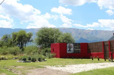 a red building with a painting on the side of it at Cabañas Las Troncas in Merlo