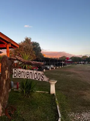a sign that says bernethos sitting in the grass at Cabañas Las Troncas in Merlo