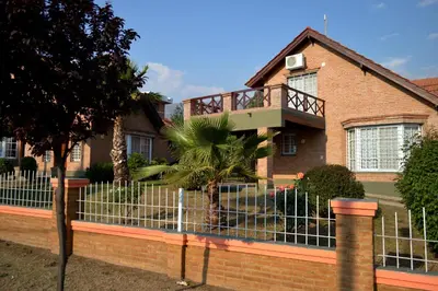 a house with a fence in front of it at Cabañas Quilquelen in Merlo
