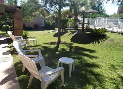 a group of chairs and a table in a yard at Cabañas Quilquelen in Merlo