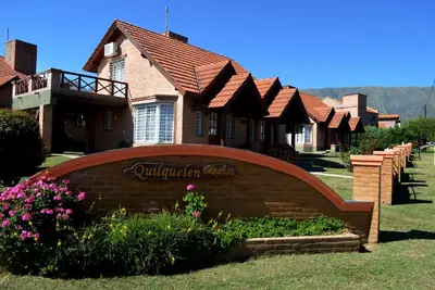 a house with a sign in front of it at Cabañas Quilquelen in Merlo
