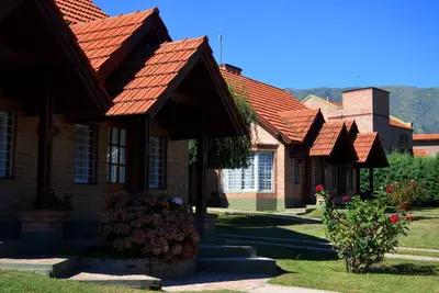 a row of brick houses with red roofs at Cabañas Quilquelen in Merlo