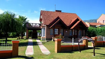 a small house with a fence in front of it at Cabañas Quilquelen in Merlo