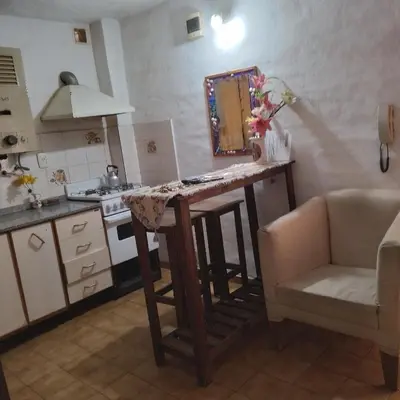 a kitchen with a table with a mirror and a sink at TEMPORARIO CORDOBA in Cordoba