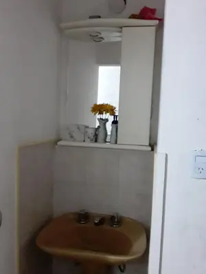 a bathroom with a wooden sink and a mirror at TEMPORARIO CORDOBA in Cordoba